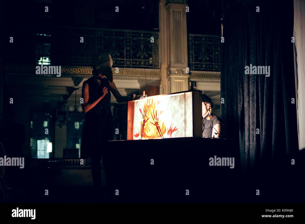 Side angle view of a shadow puppet show, Halloween at Johns Hopkins University's George Peabody Library, 2015. Courtesy Eric Chen. Stock Photo