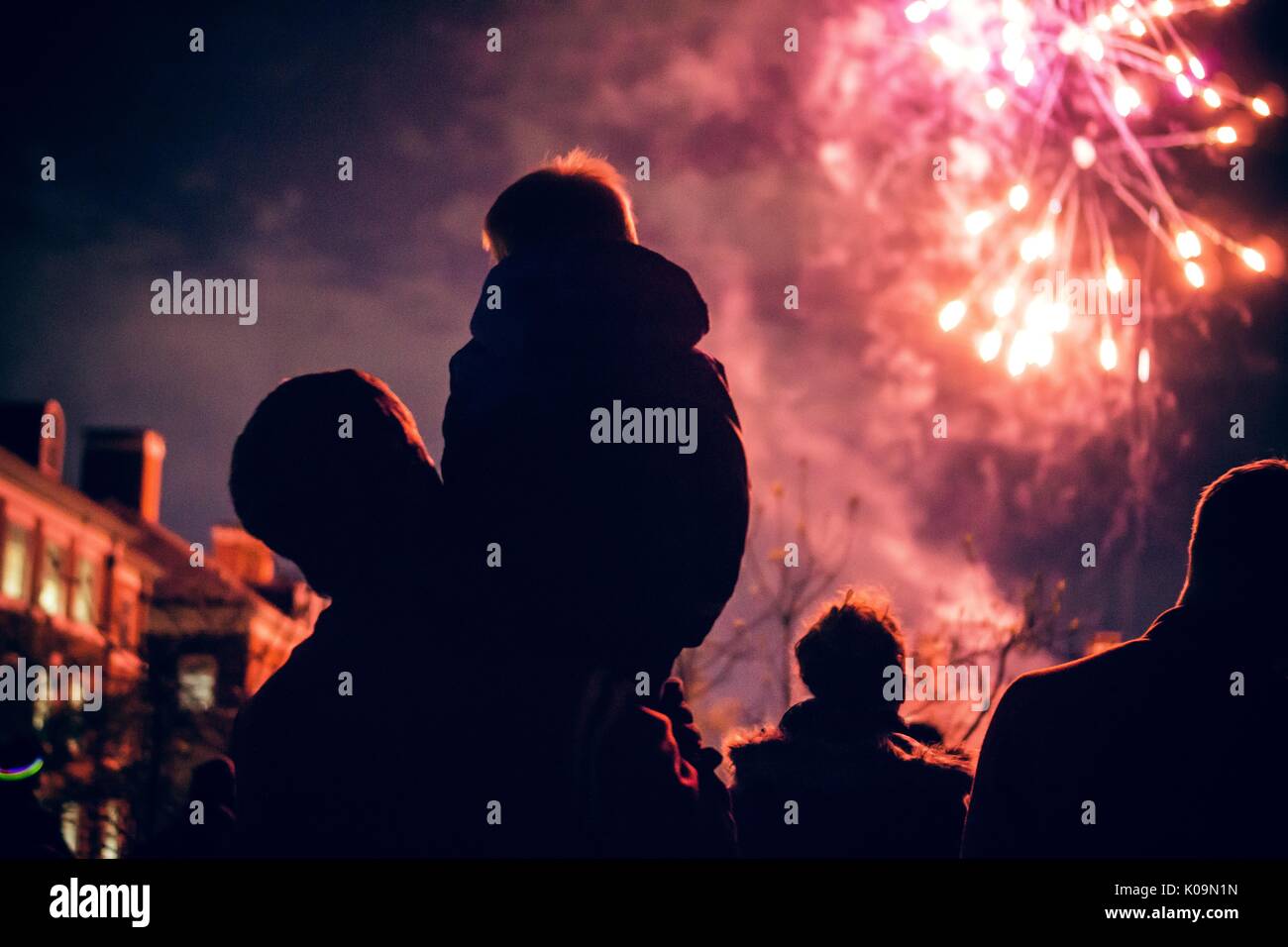 Child sitting on man's shoulder as they watch fireworks on Keyser Quad, one of Johns Hopkins University's social gathering areas, 2015. Courtesy Eric Chen. Stock Photo
