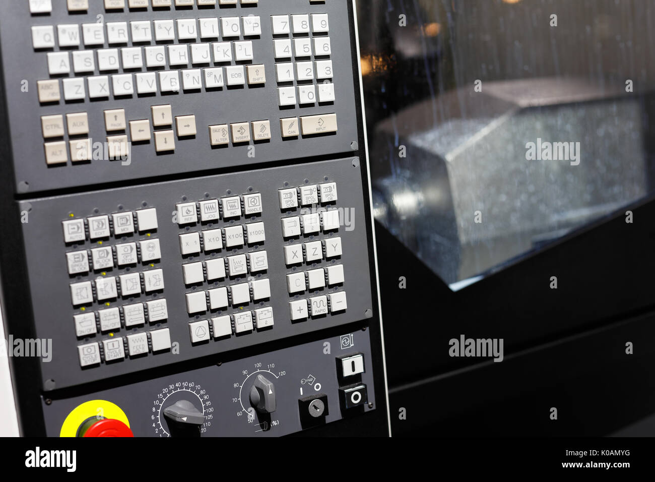CNC machining center with control panel on the foreground. Selective focus. Stock Photo