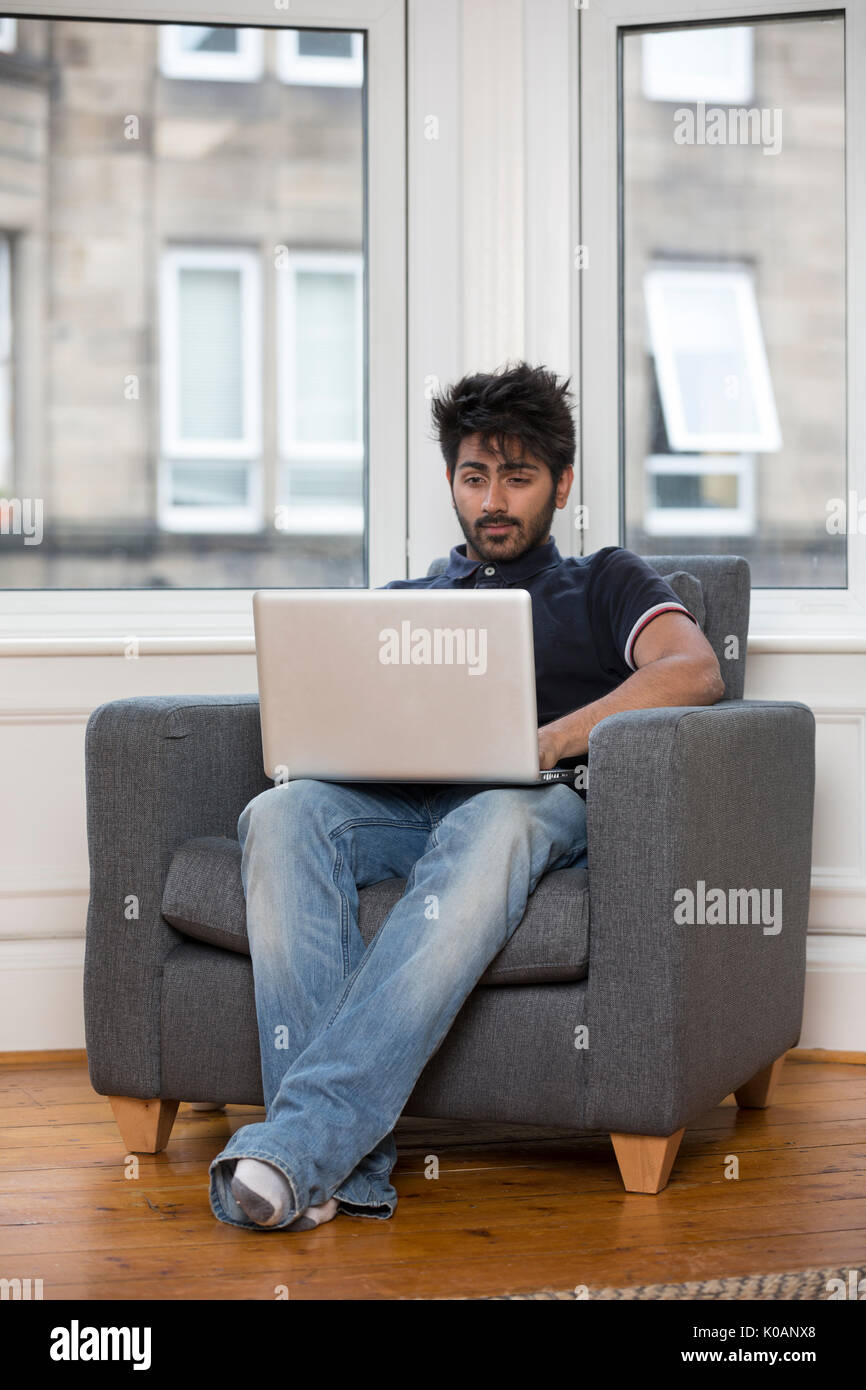 Arab man sitting on sofa hi-res stock photography and images - Alamy