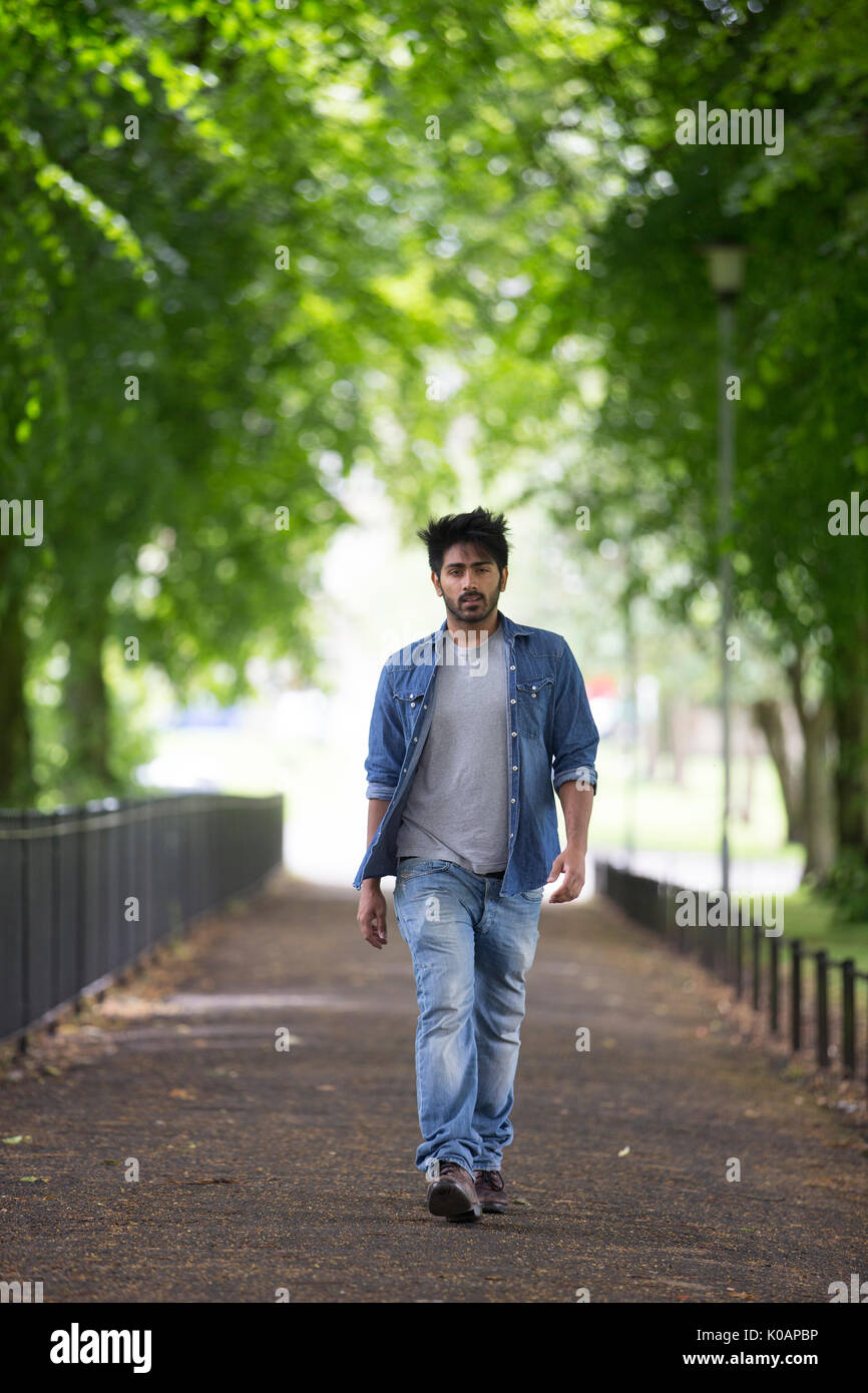 Portrait of a trendy Indian man walking in a city park. Stock Photo