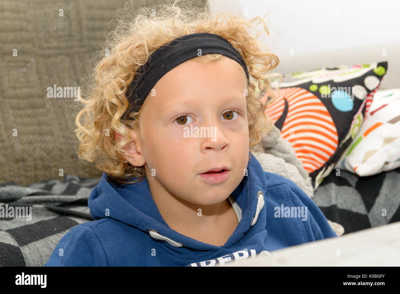 Portrait Of A Little Boy With Blond And Curly Hair Stock Photo