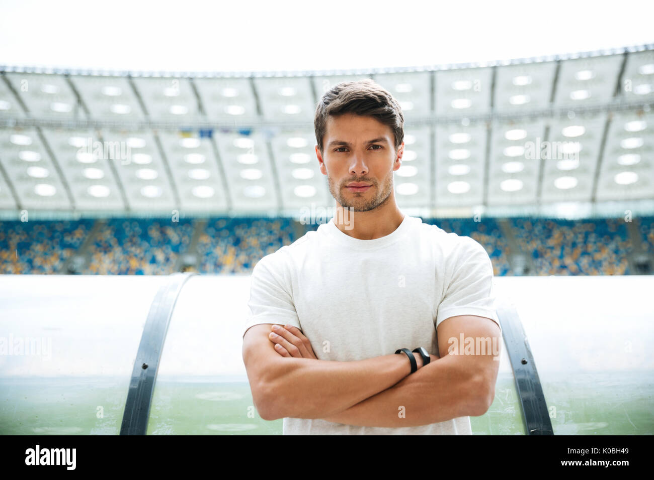 Male athlete standing arms hi-res stock photography and images - Alamy