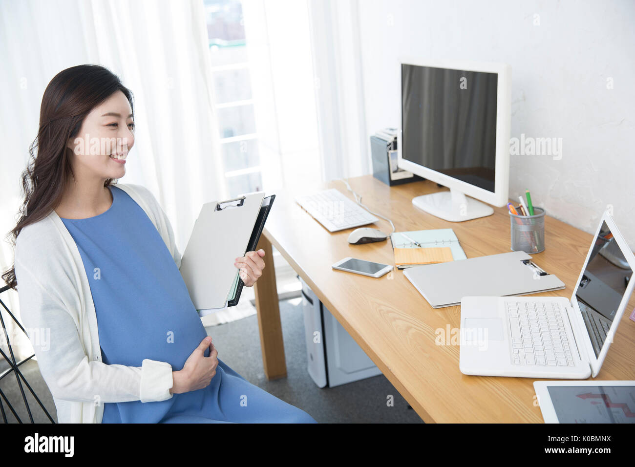 Smiling pregnant businesswoman working from home Stock Photo Alamy