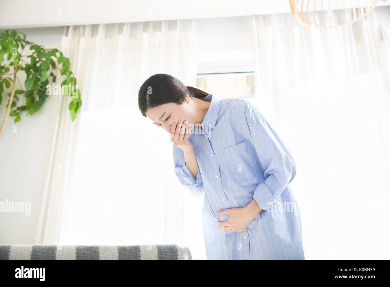 Pregnant woman having morning sickness Stock Photo