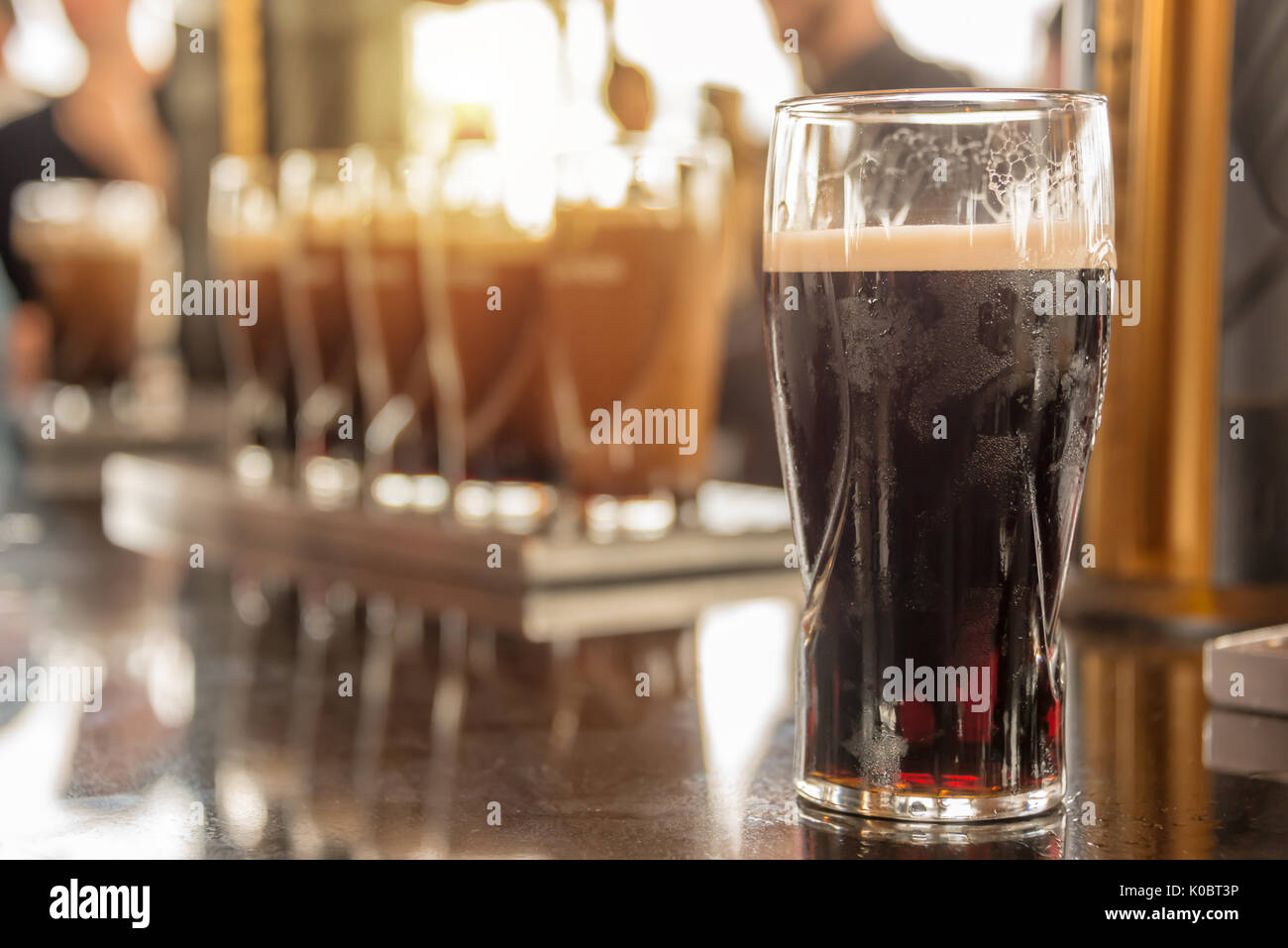 Close up of a glass of stout beer in a bar Stock Photo