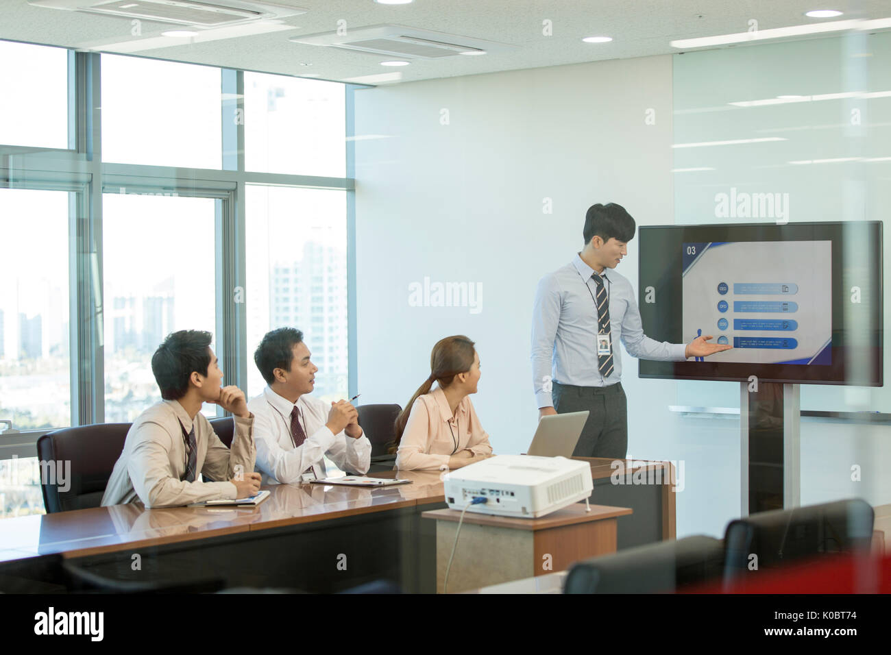 Young businessman having a presentation in front of his coworkers Stock Photo