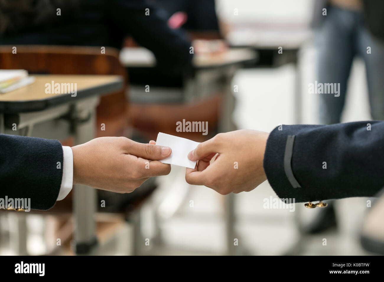 School students passing a memo in class Stock Photo