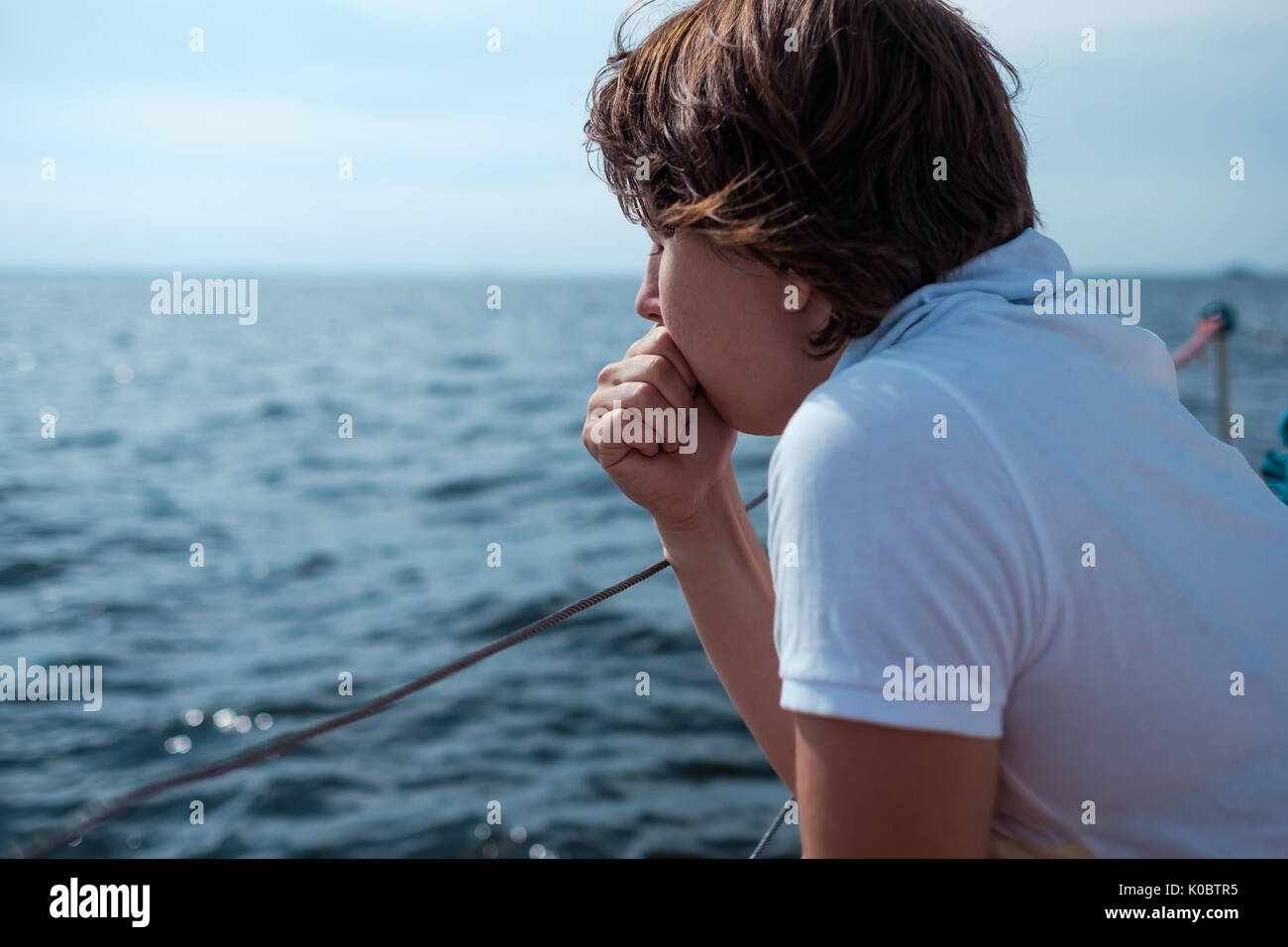 Young woman suffer from seasickness during vacation on boat Stock Photo