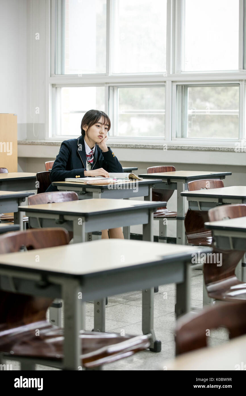 korean schoolgirl Korean school girl gloomy in classroom Stock Photo - Alamy
