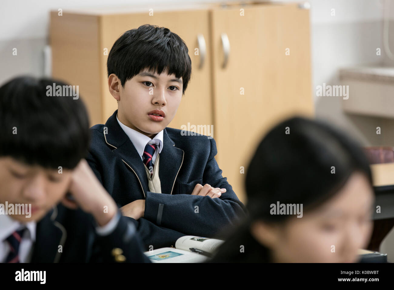 Portrait of school boy neglected by his classmates Stock Photo