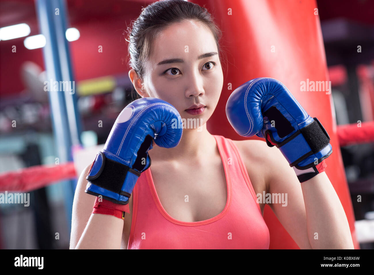 Portrait of young female boxer with gloves posing Stock Photo