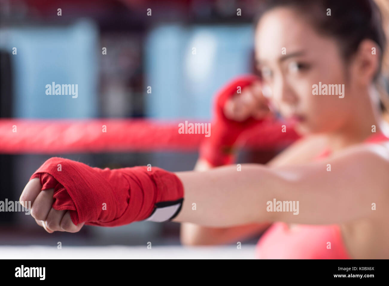 Portrait of young female boxer exercising Stock Photo