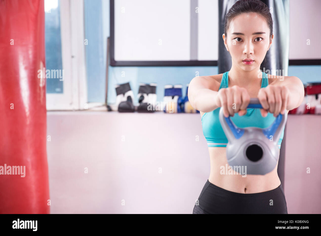 Young woman in sportswear exercising at gym Stock Photo