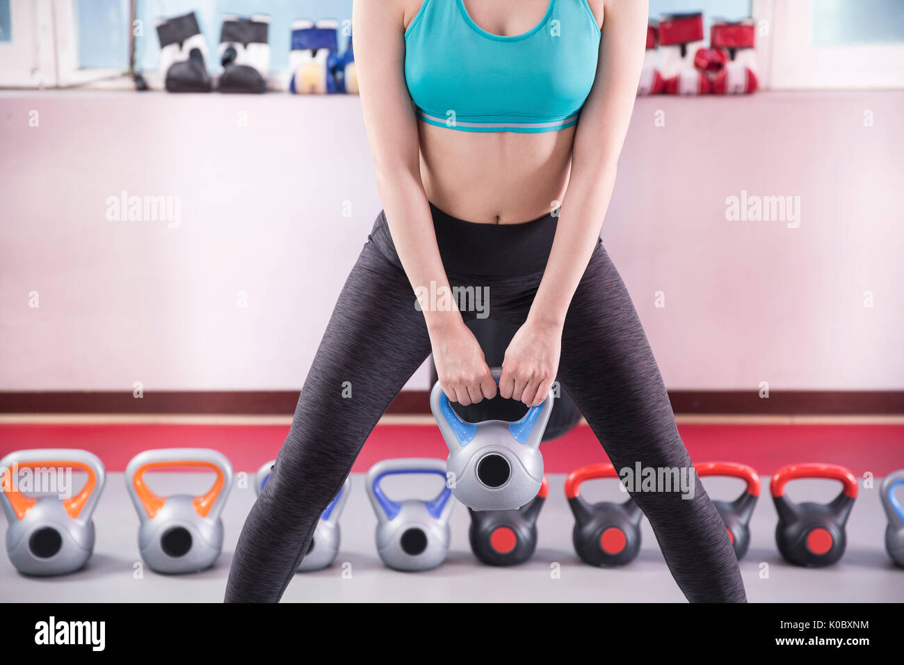 Young woman in sportswear exercising at health club Stock Photo