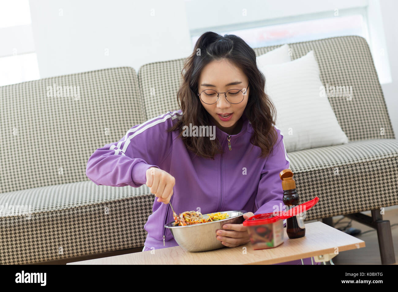 Young smiling NEET woman having meal Stock Photo
