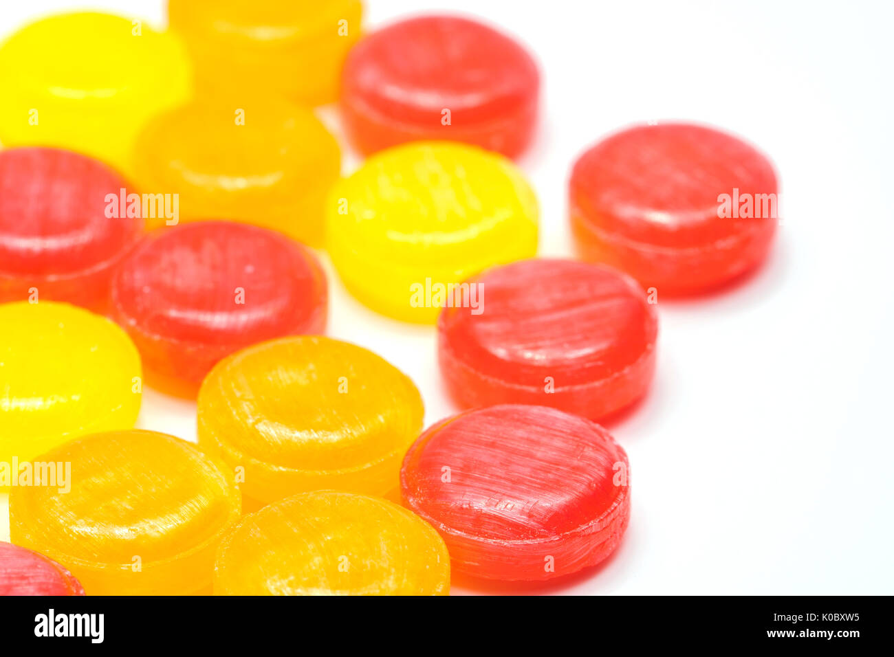 Medical lozenges for relief cough, sore throat and throat irritation isolated on white background. Cough and colds drop. Colorful cough pastille. Red, Stock Photo