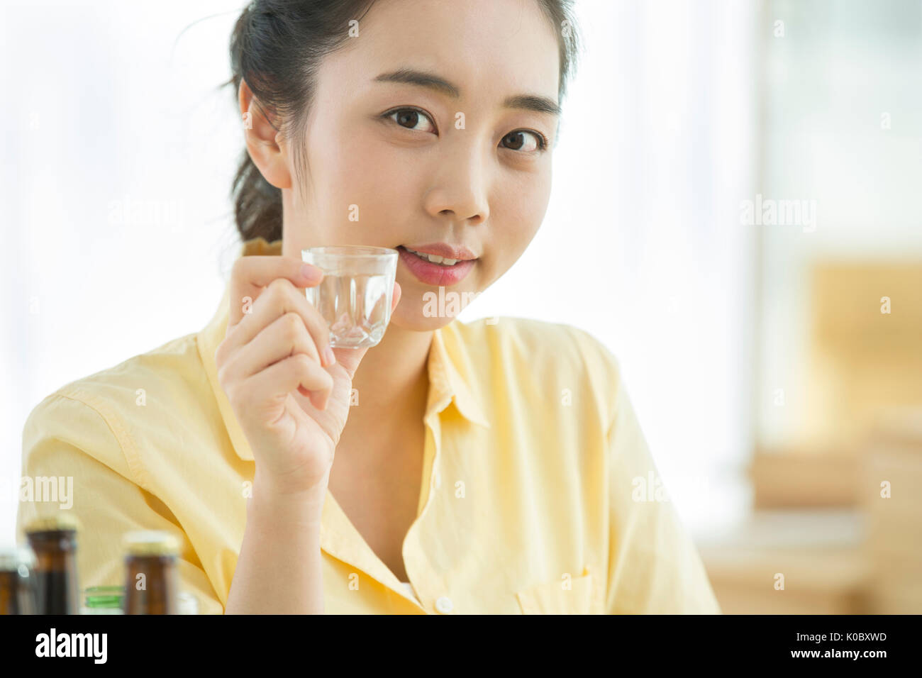 Portrait of single woman drinking Stock Photo