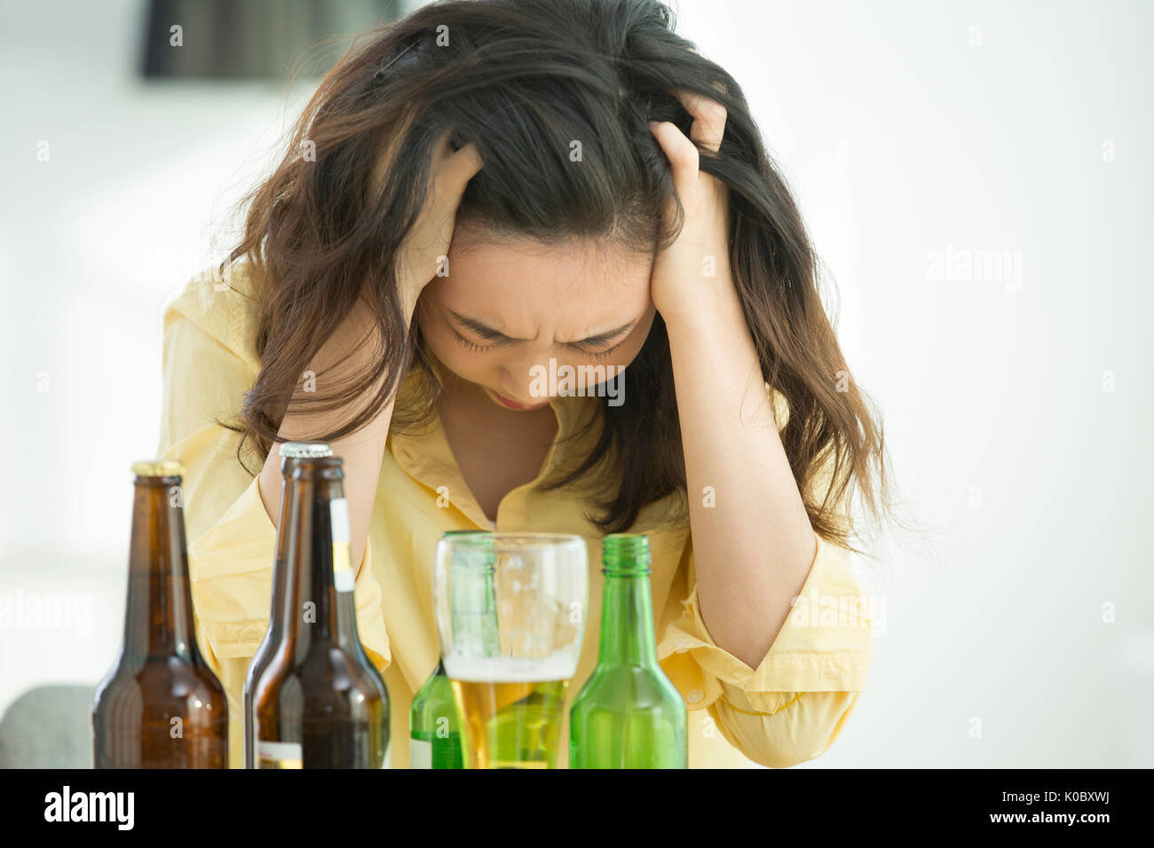 Portrait of stressful single woman drinken Stock Photo