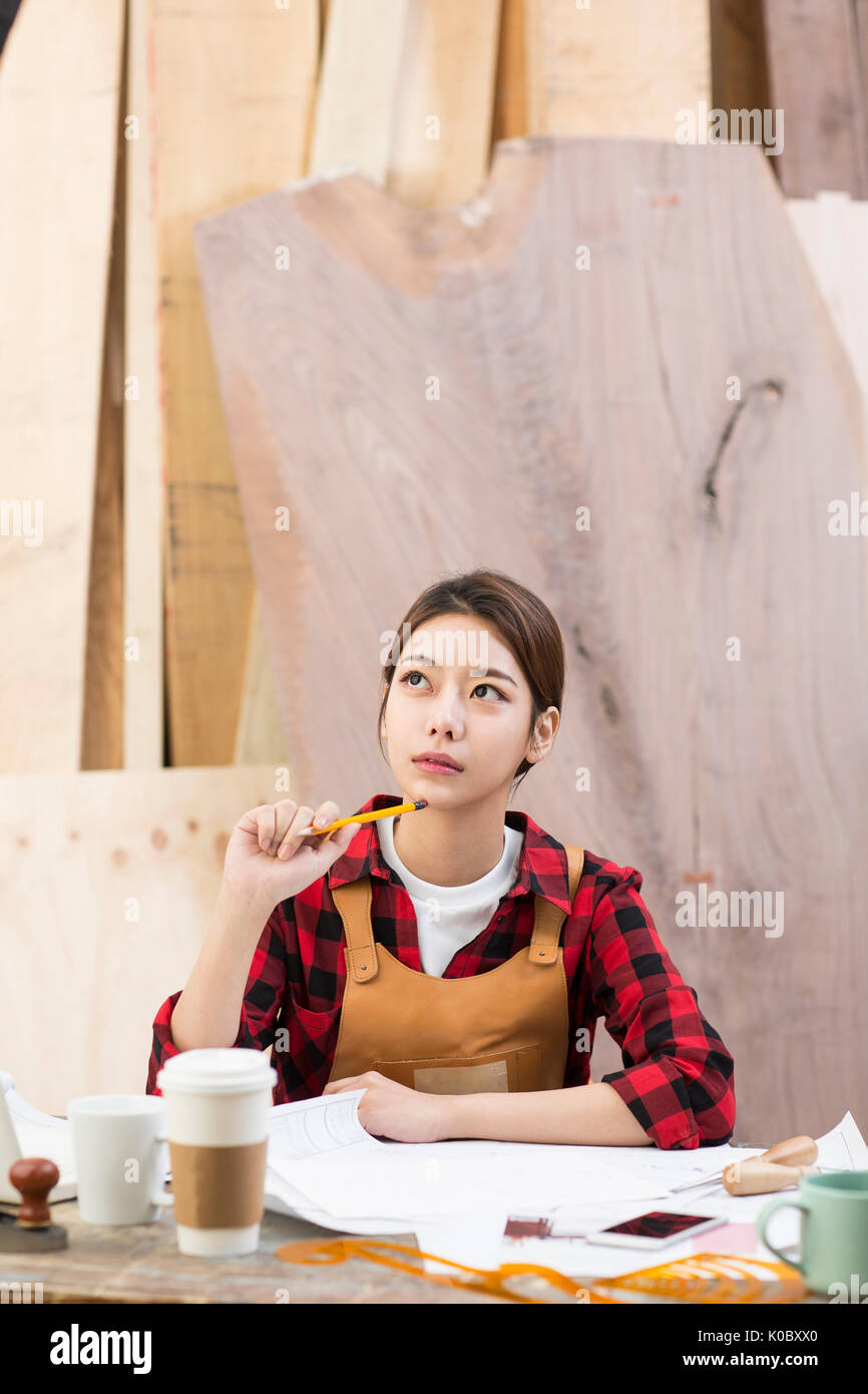 Portrait of female furniture designer thinking Stock Photo