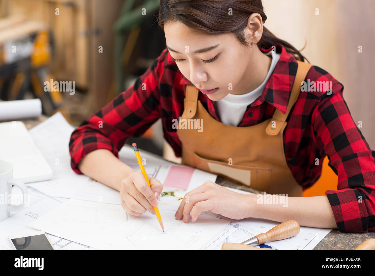 Portrait of female furniture designer drawing Stock Photo Alamy