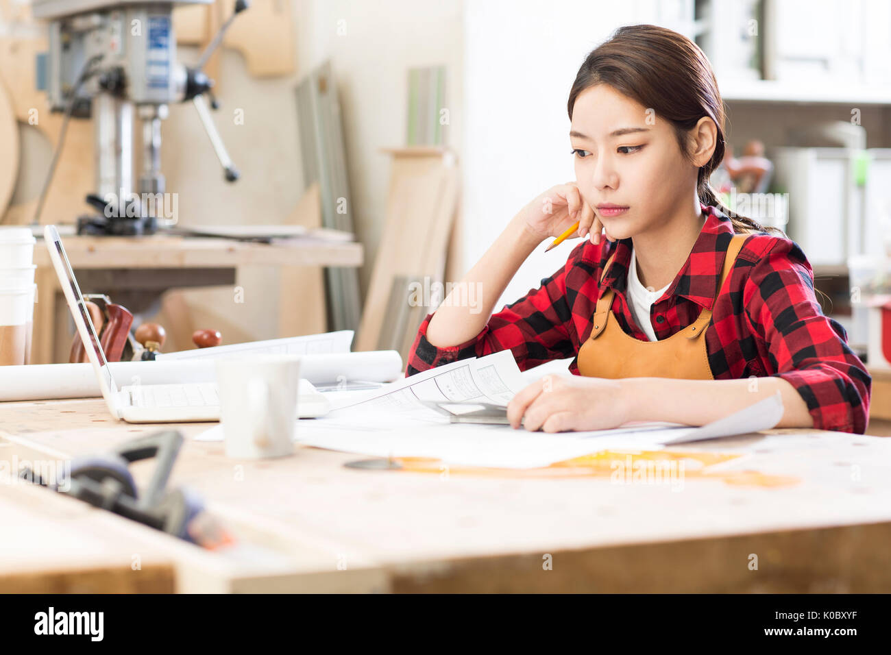 Side view portrait of female furniture designer thinking Stock Photo