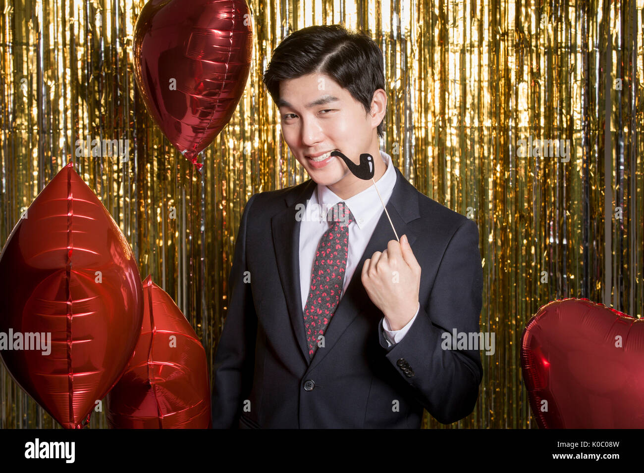 Portrait of young man in suit posing ciga-chomping Stock Photo