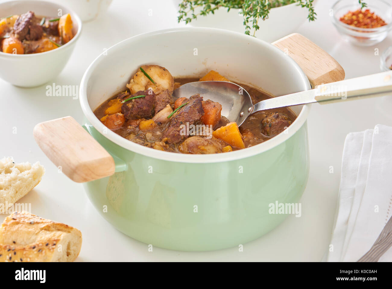 A pot of hearty beef stew with carrots, onions and squash. Stock Photo