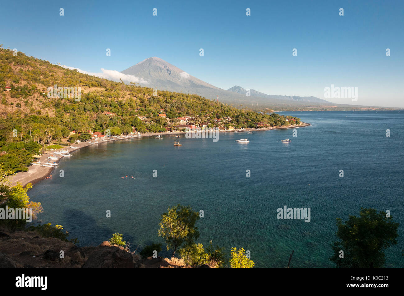 Looking across Jemeluk bay at Amed  with Gunung Agung volcano in the background, Eastern Bali, Indonesia. Stock Photo