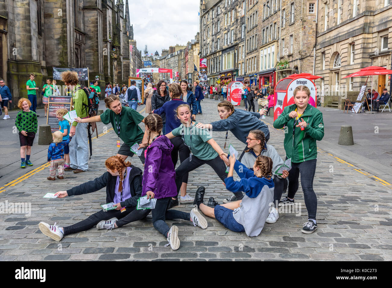 EDINBURGH, UNITED KINGDOM - AUGUST 16, 2017 - A group of young girls advertises a theatrical performance along the Royal Mile of Edinburgh during the  Stock Photo