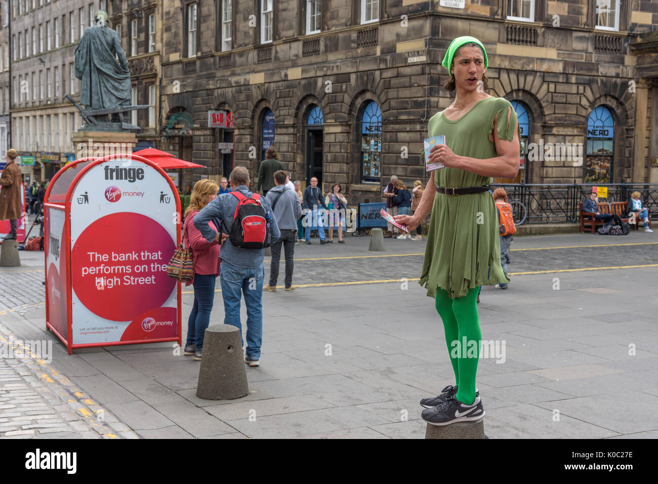 EDINBURGH, UNITED KINGDOM - AUGUST 16, 2017 - A boy advertises a theatrical performance along the Royal Mile of Edinburgh during the 70th anniversary  Stock Photo