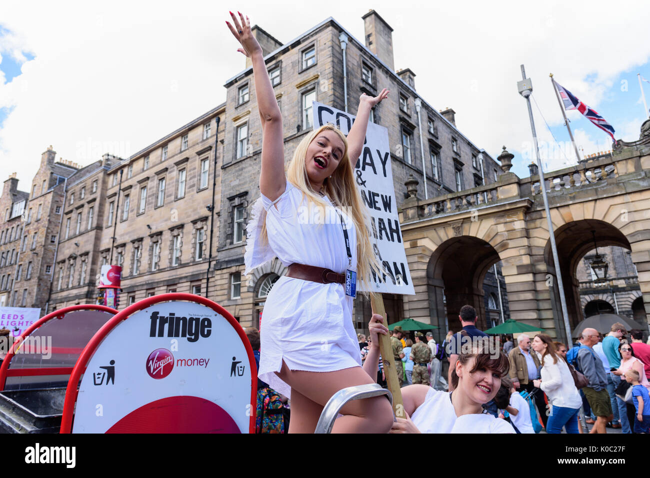 EDINBURGH, UNITED KINGDOM - AUGUST 15, 2017 - A girl advertises a theatrical performance along the Royal Mile of Edinburgh during the 70th anniversary Stock Photo
