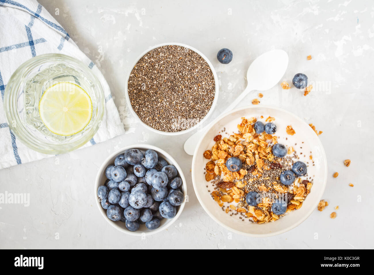 granola with yogurt and mini cheesecakes with blueberries for breakfast. Stock Photo