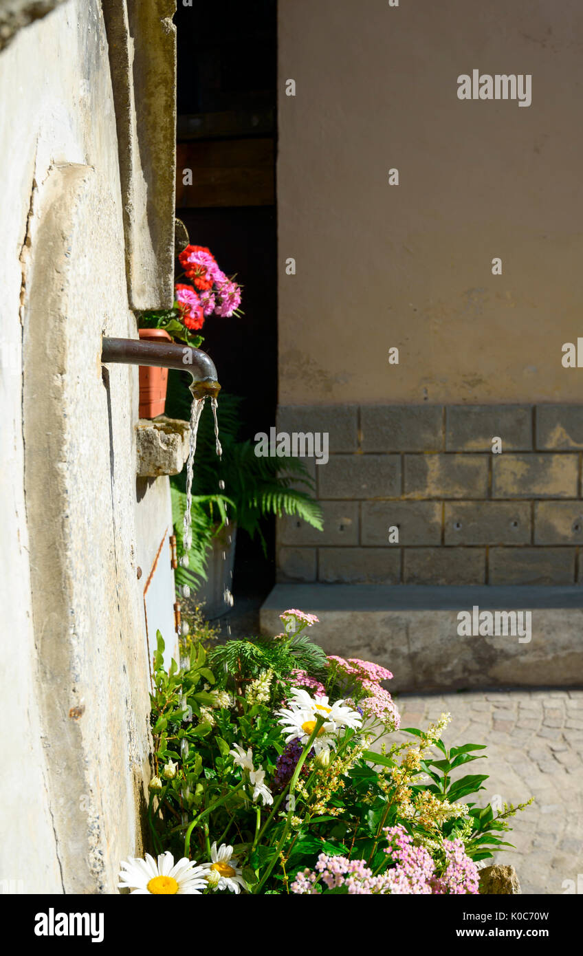 Old rustic water pipe with running drinking water Stock Photo - Alamy
