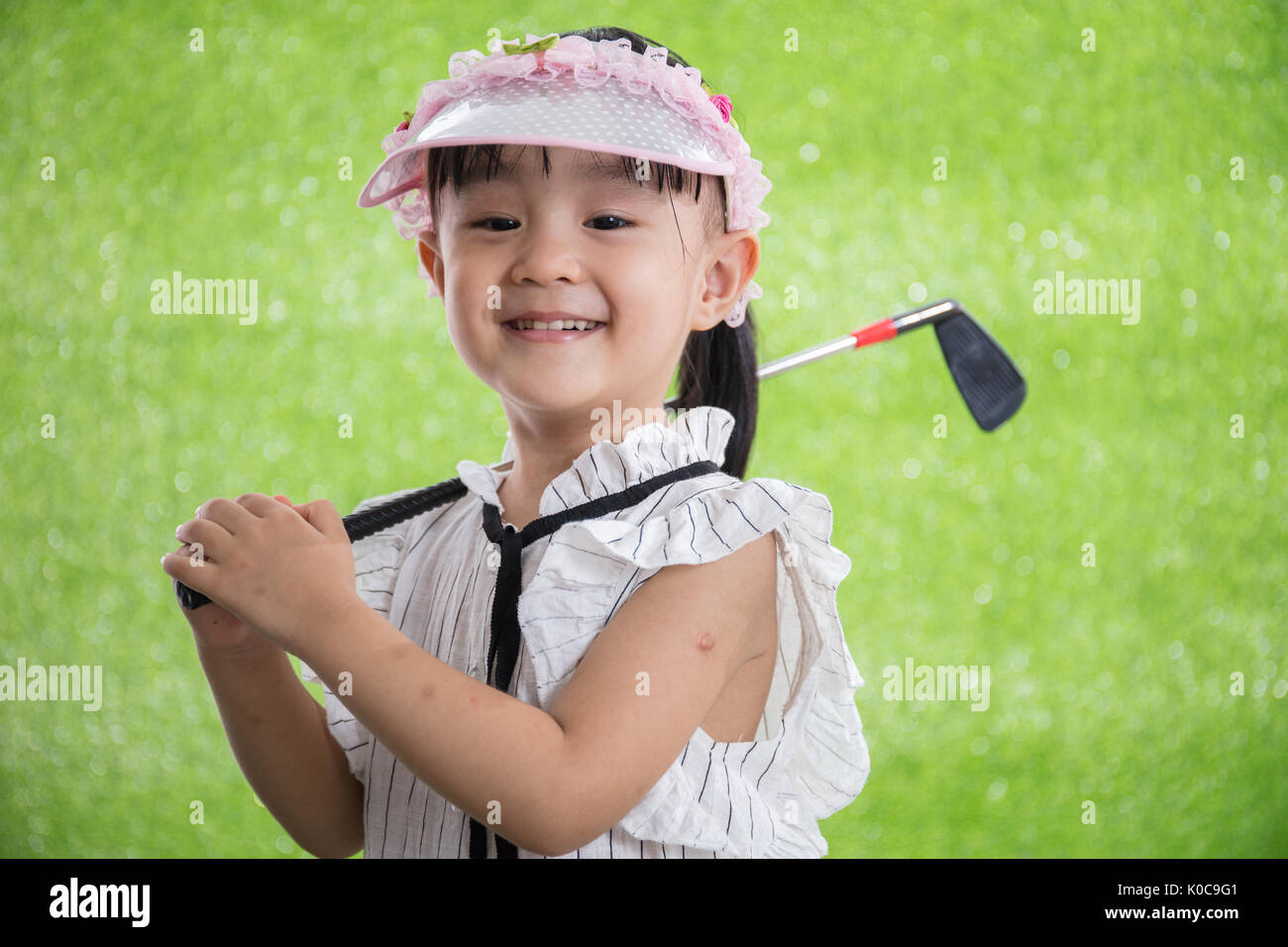 Asian Chinese little girl playing golf on green grass Stock Photo Alamy