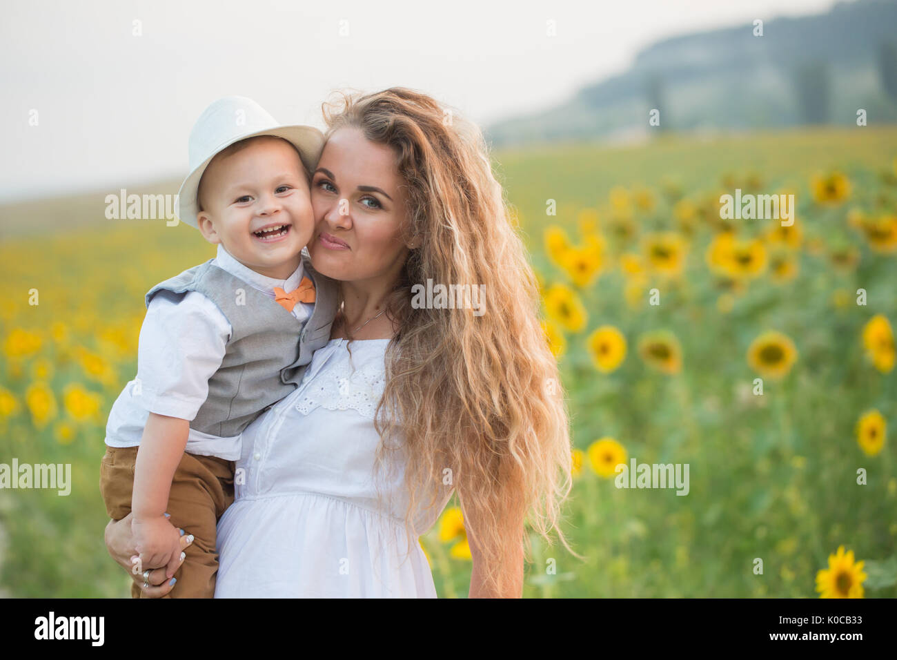 Mother with baby son in sunflower field Stock Photo - Alamy