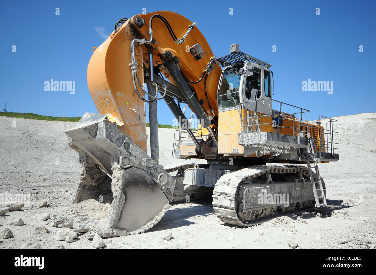 Excavator in a chalk rock quarry. mining industry Stock Photo Alamy