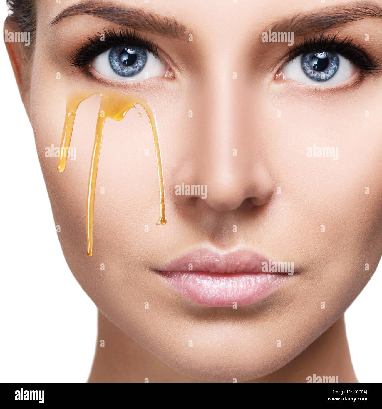 Beautiful woman with honey on face Stock Photo Alamy