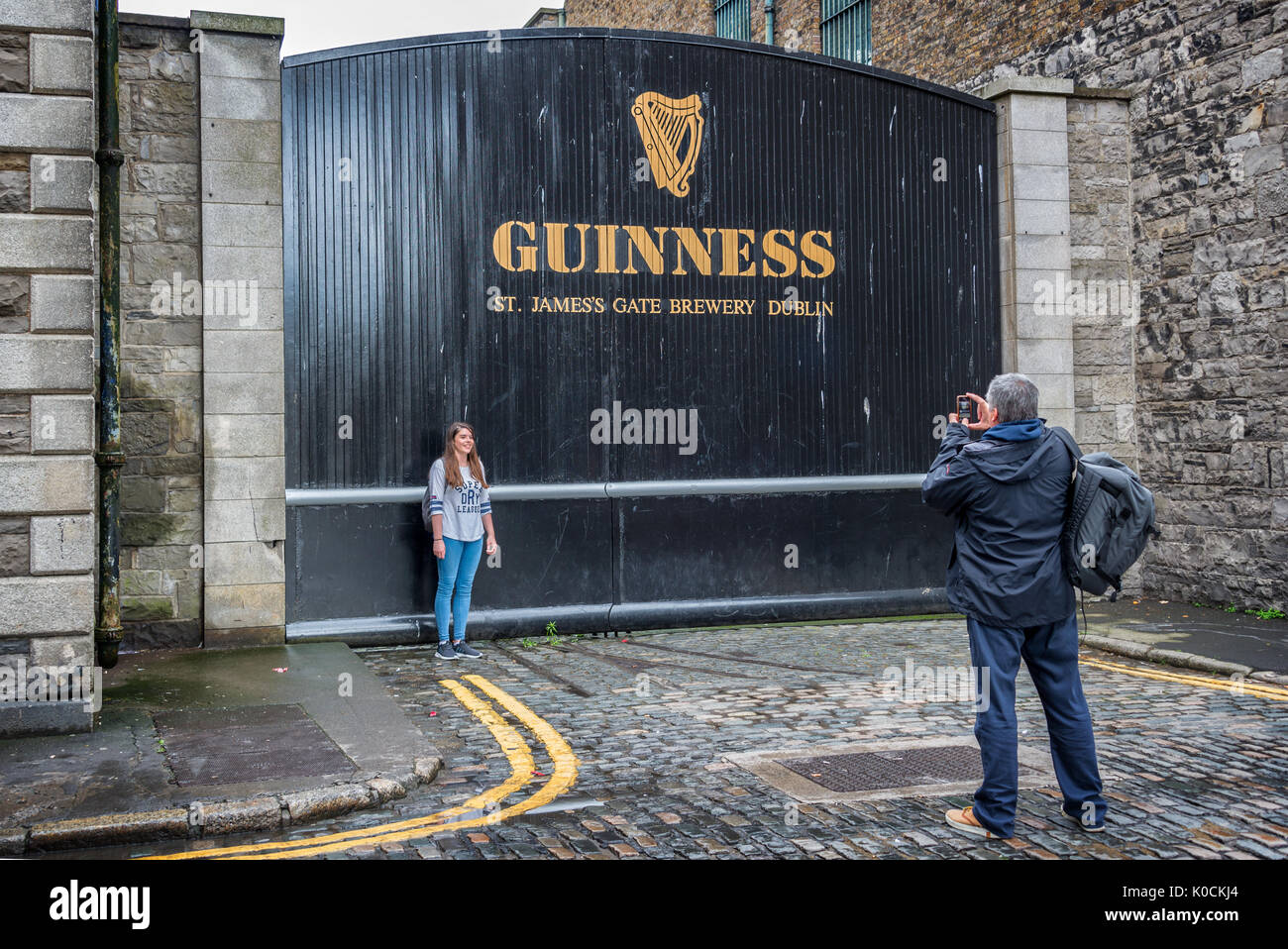 DUBLIN, IRELAND - AUGUST 14: Tourists taking photo  at the St James Gate of the Guinness storehouse brewery. The Guinness Storehouse is a popular tour Stock Photo