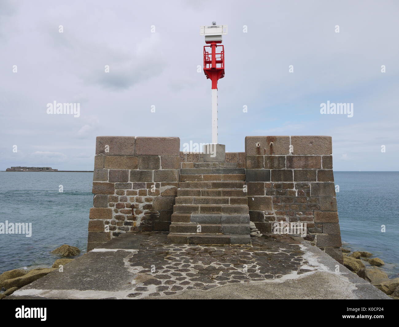 A maritime beacon on the wavebreaker of the port of Cherbourg Stock Photo