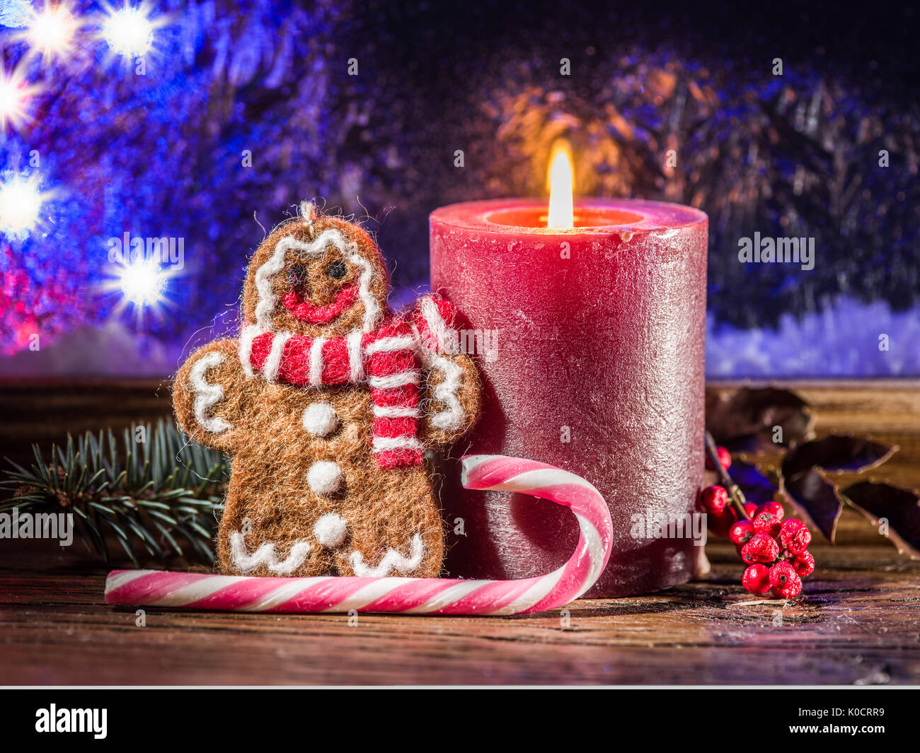 Christmas candle, ginger man toy and candy canes. Christmas symbols. Stock Photo
