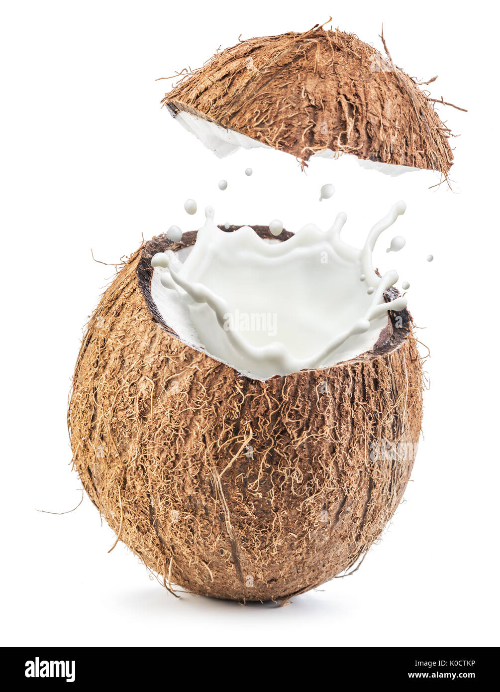 Coconut fruit and milk splash inside it Stock Photo Alamy