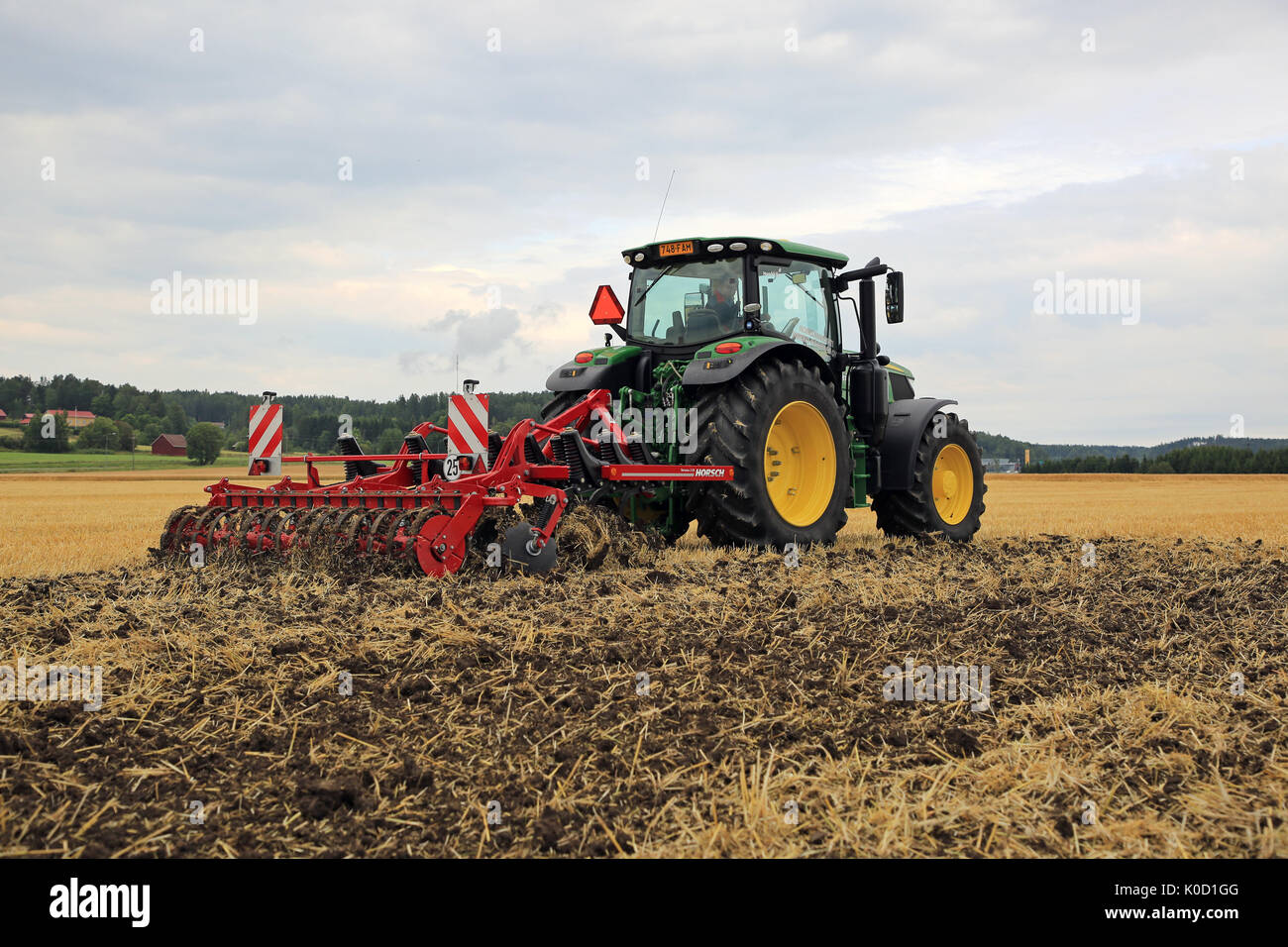 SALO, FINLAND - AUGUST 18, 2017: Farmer works with John Deere 6155R tractor and Horsch Terrano 3FX cultivator on Puontin Peltopaivat 2017 Agricultural Stock Photo