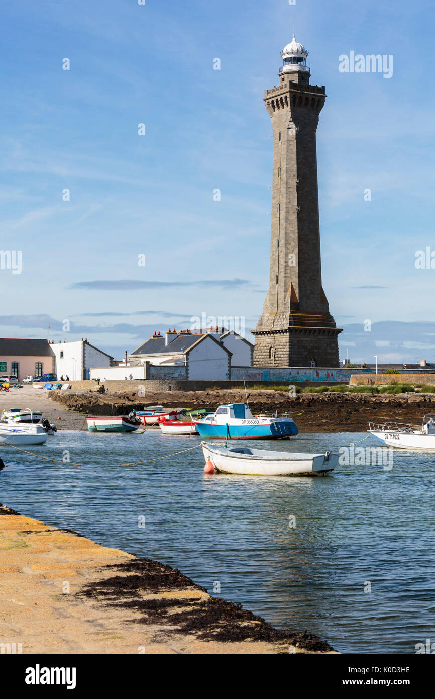 Lighthouse with pier and boats. Penmarch, Finistère, Brittany, France. Stock Photo