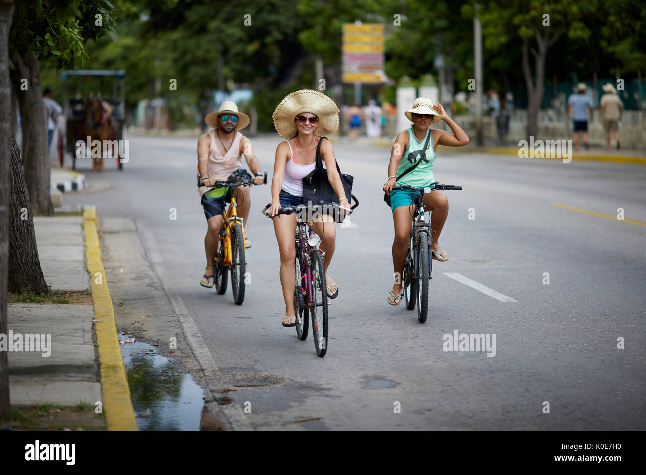 Cuban tourists cycling pedal bikes at Varadero, Cuba, a Caribbean island nation under communist rule Stock Photo