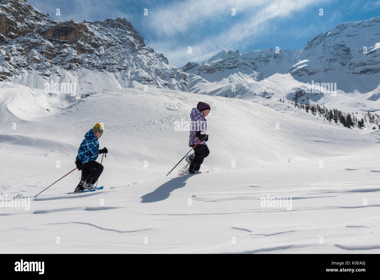 Fanes, Dolomites, South Tyrol, Italy. Children wearing snowshoes walking in the mountains of the Fanes Stock Photo