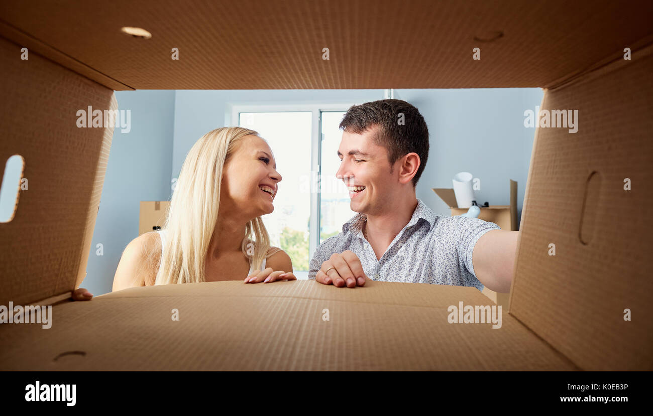 A young couple unpacks boxes.  Stock Photo