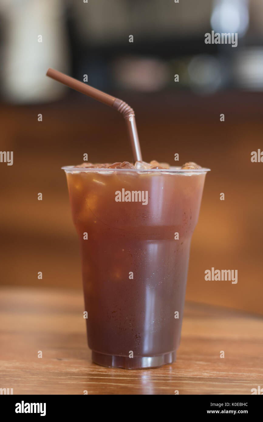 Iced Americano coffee in take away cup (plastic glass) on the wood ...