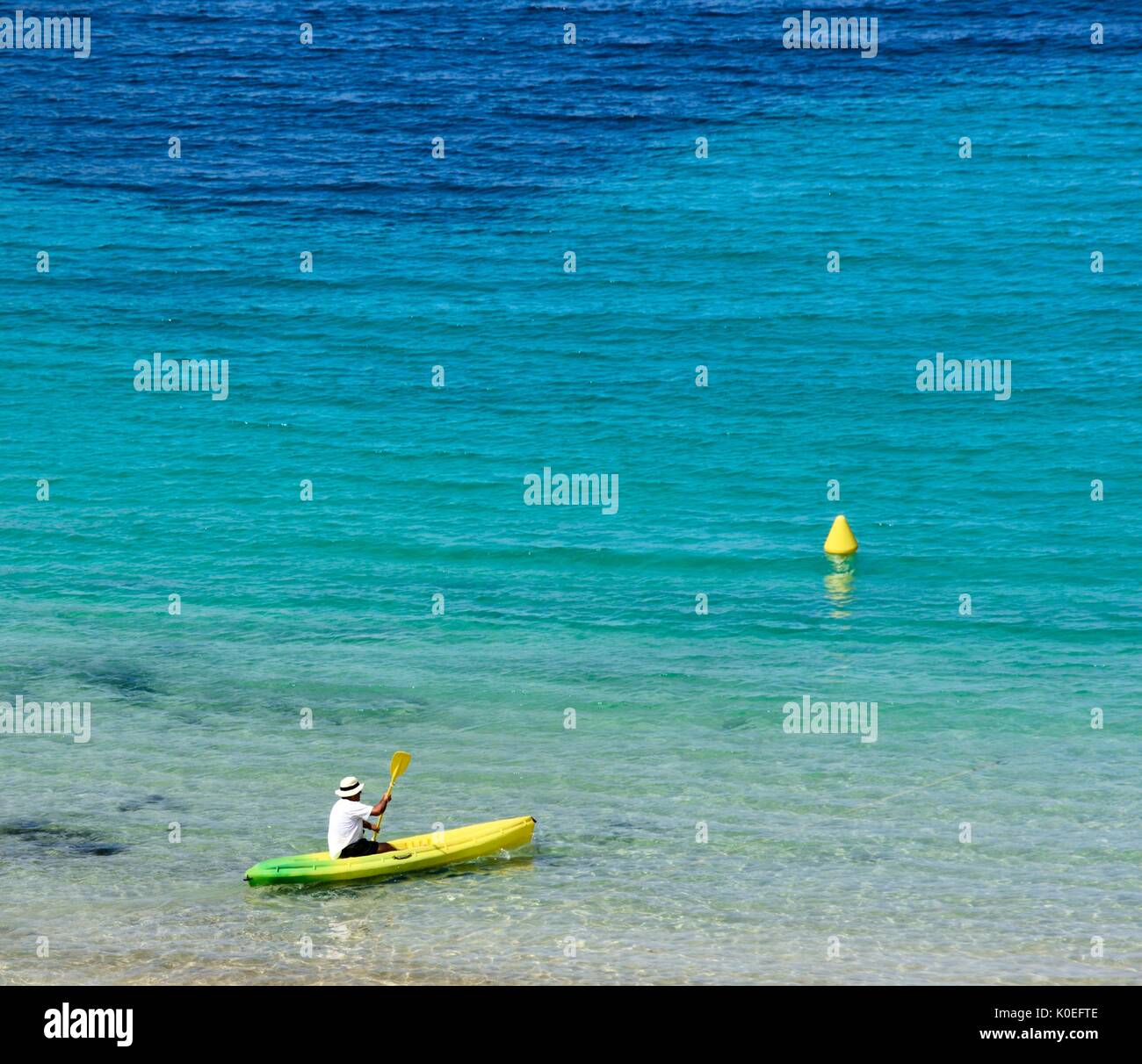 Man kayaking in shallow water Menorca minorca Stock Photo Alamy