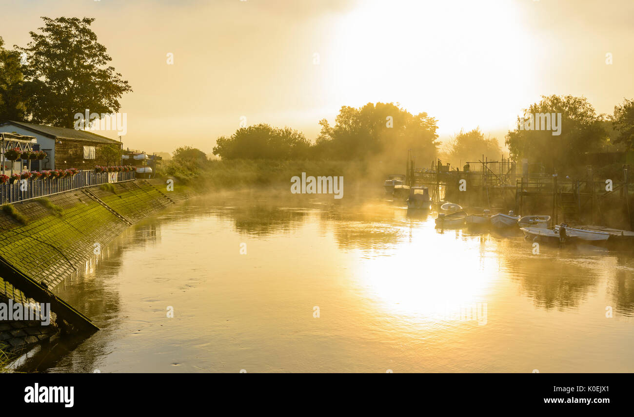 Evaporating steam fog rising over the River Arun on a cold morning in Arundel, West Sussex, England, UK. Stock Photo